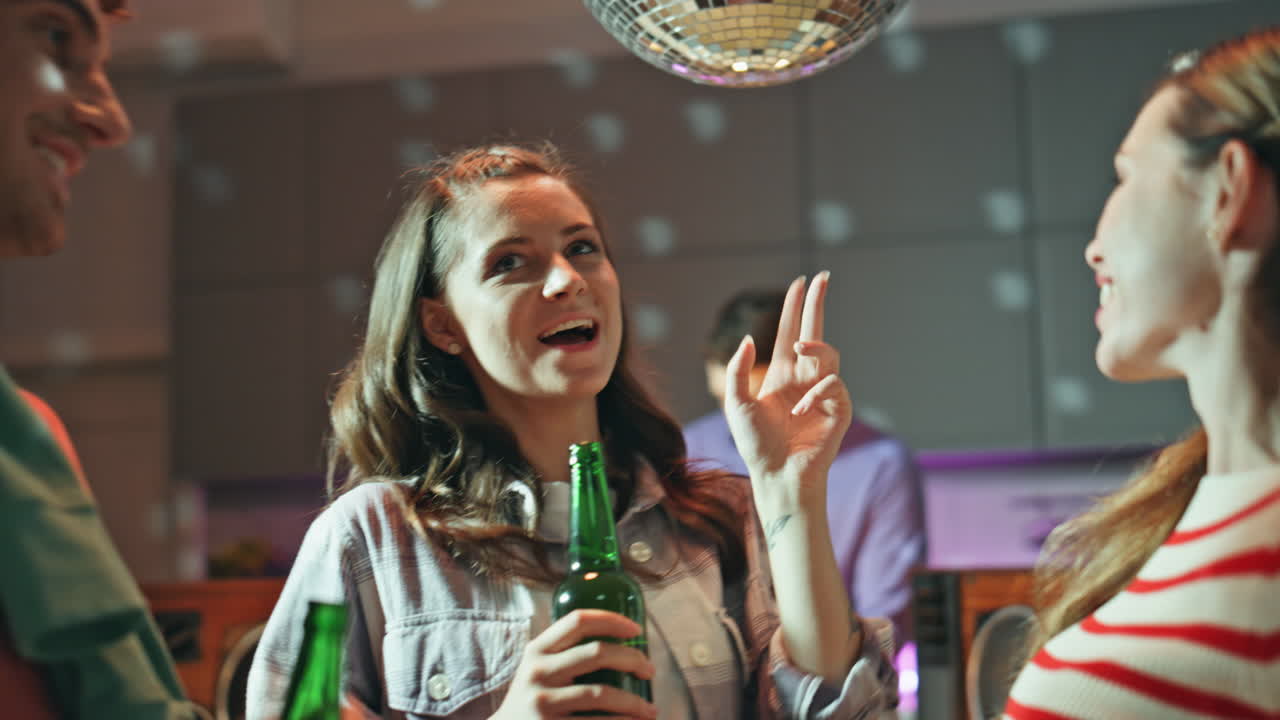 Laughing colleagues dancing disco party in apartment close up. Excited people