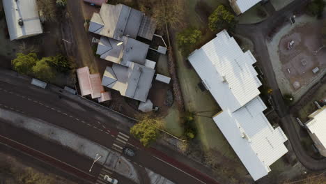 Aerial,-top-down,-drone-shot-over-streets,-buildings-and-trees,-on-a-sunny,-fall-day,-in-Pitajanmaki,-Helsinki,-Uusimaa,-Finland