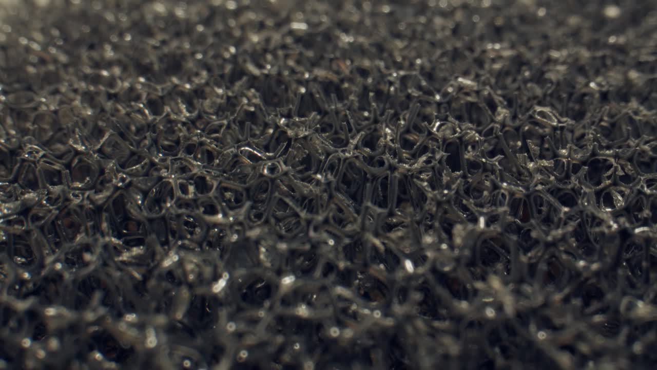 Abstract Close-Up of Dark Cellular Foam Texture