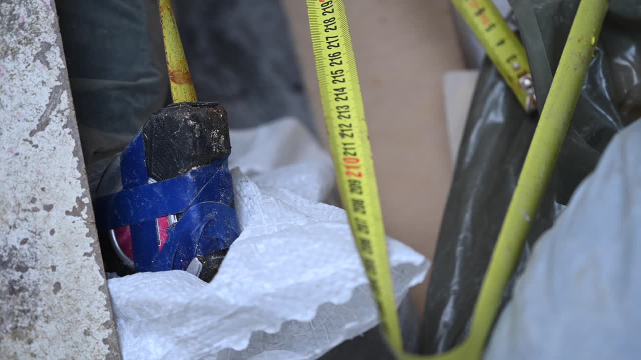 Old broken tape measure in construction environment. Close up