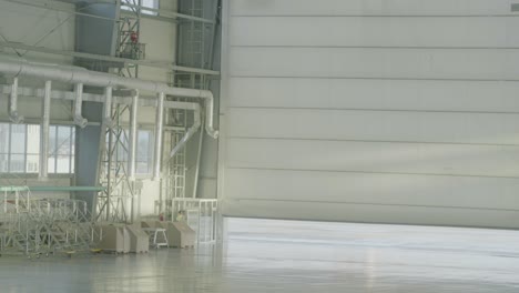 empty airplane hangar with workers