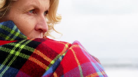 thoughtful mature woman in shawl feeling cold