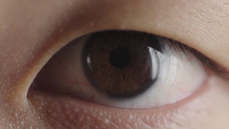 close up young asian man eye opening looking iris detail reflection