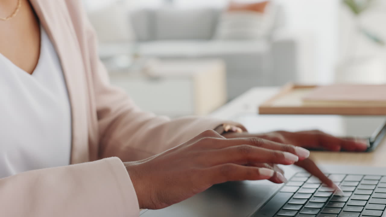 Hands of a business woman typing on a laptop to