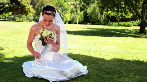 content bride sitting on the grass