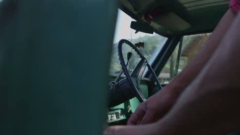 a driver exits an old pickup truck