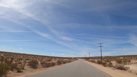 driving through the mojave desert on a hot and sunny day - driver point of view