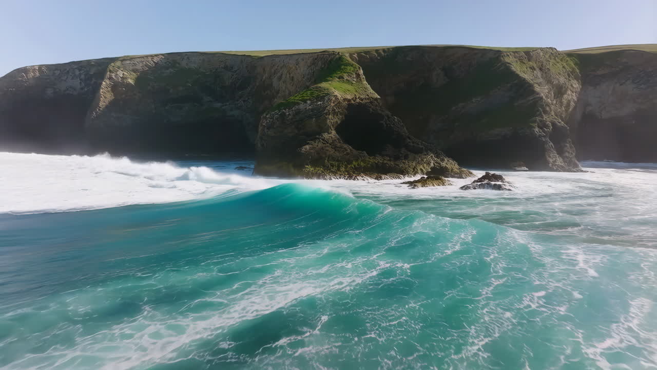 Dramatic Ocean Waves Crashing Against Rugged Cliffs