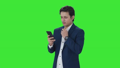 Indian-businessman-using-mobile-phone-Green-screen