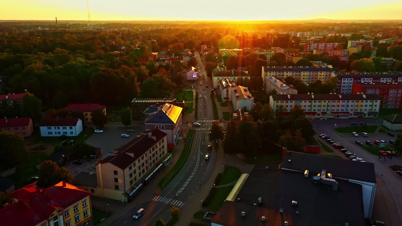 Sunset Over Valmiera City Streets With Glowing Sunight and Urban Skyline