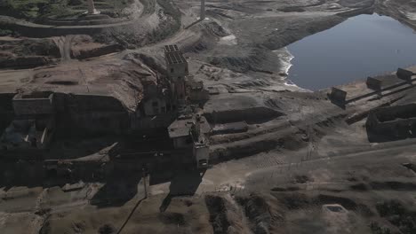 Drone-view-of-old-ruined-buildings-and-lake-or-pond-in-Sao-Domingos-Mine-in-Portugal