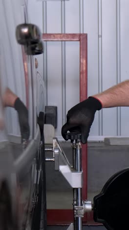 mechanic performing wheel alignment on a car