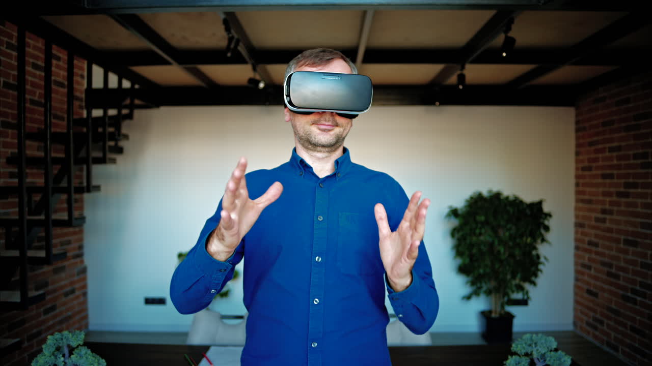 Man gesturing while using a Virtual Reality headset in an office