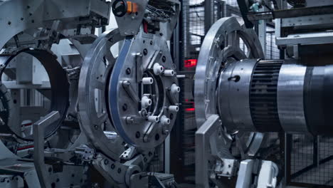 robotic tyre manufacturing equipment rotating with rubber tape at auto plant