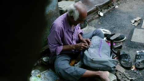 a cobbler repairing slippers of pilgrims by the roadside in the morning stock footage collection 7