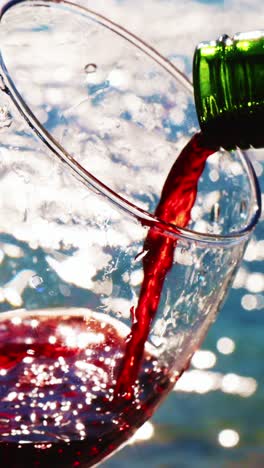 pouring red wine into a glass