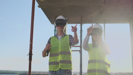 waist up portrait of two modern construction workers using vr gear to visualize projects on site copy space