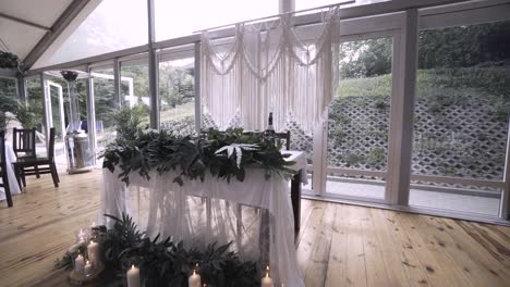 vintage boho wedding venue with lots of green decorations and candles