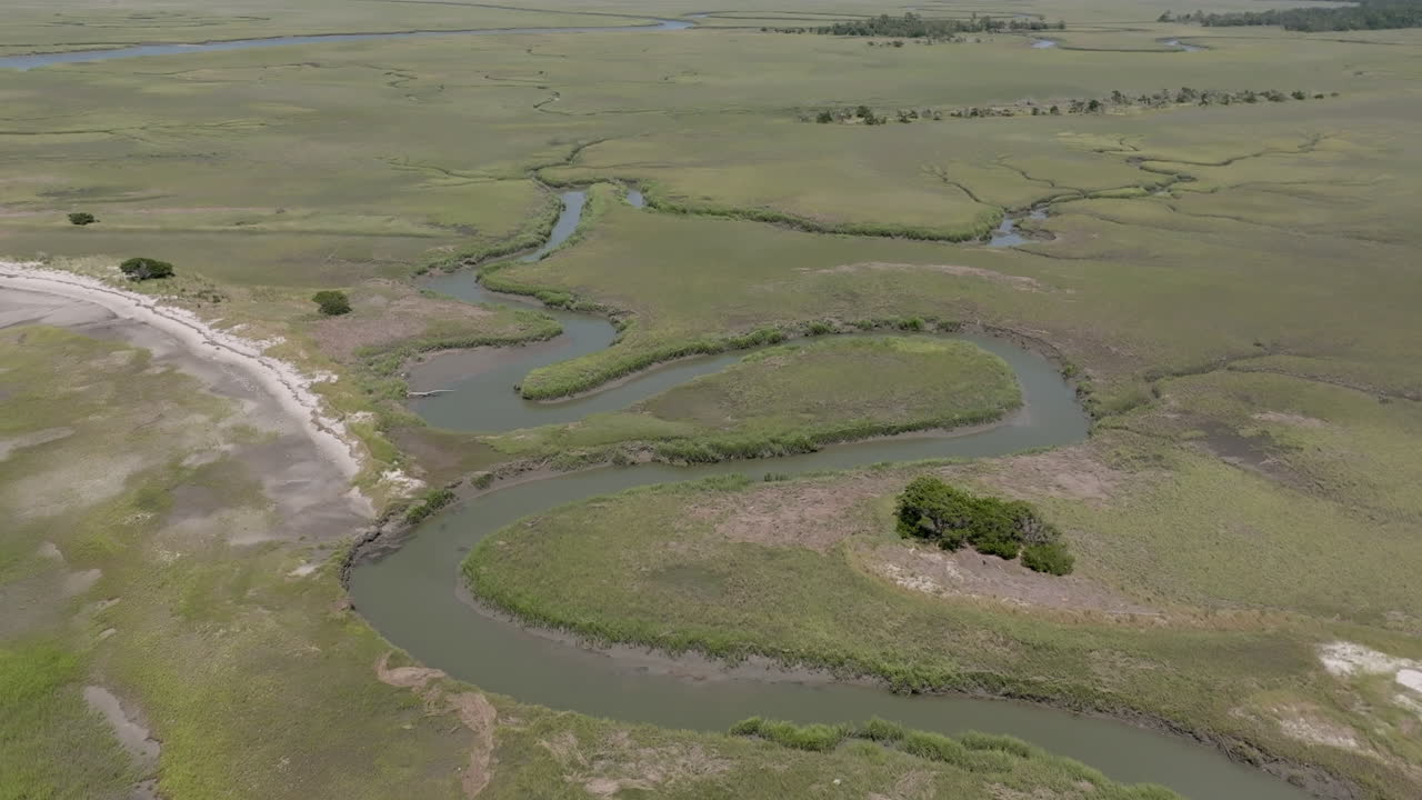 Aerial video shows winding tidal creeks weaving through lush green marshlands near Hilton Head’s coastline