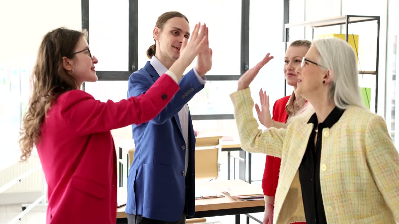 Business team high-fiving in the office