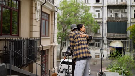 a couple hugging on a street with their dog