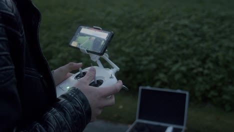 Hands-that-control-a-drone-via-a-controller-with-screen