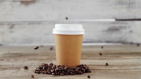 coffee beans falling on disposable cup