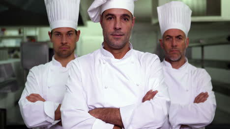 three stern chefs looking at camera