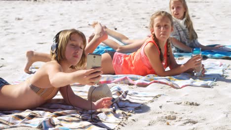 siblings taking selfie with mobile phone in beach 4k