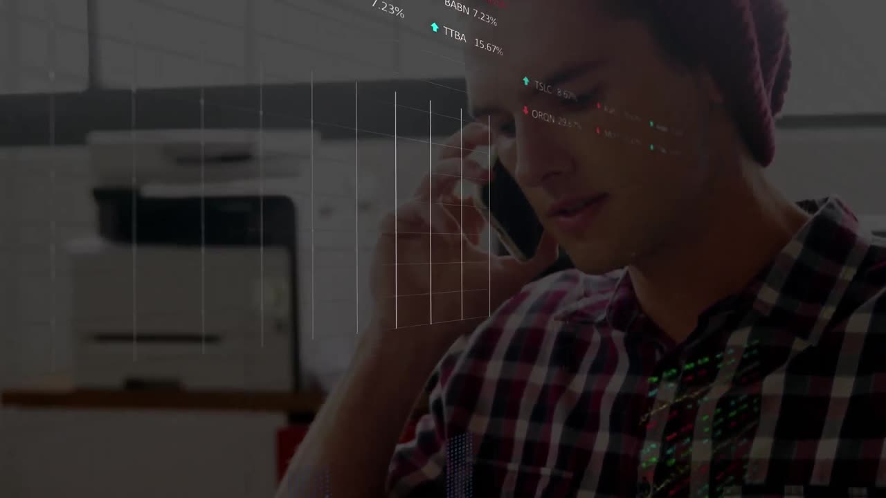 Animation of stock market data processing over caucasian man talking on smartphone at office