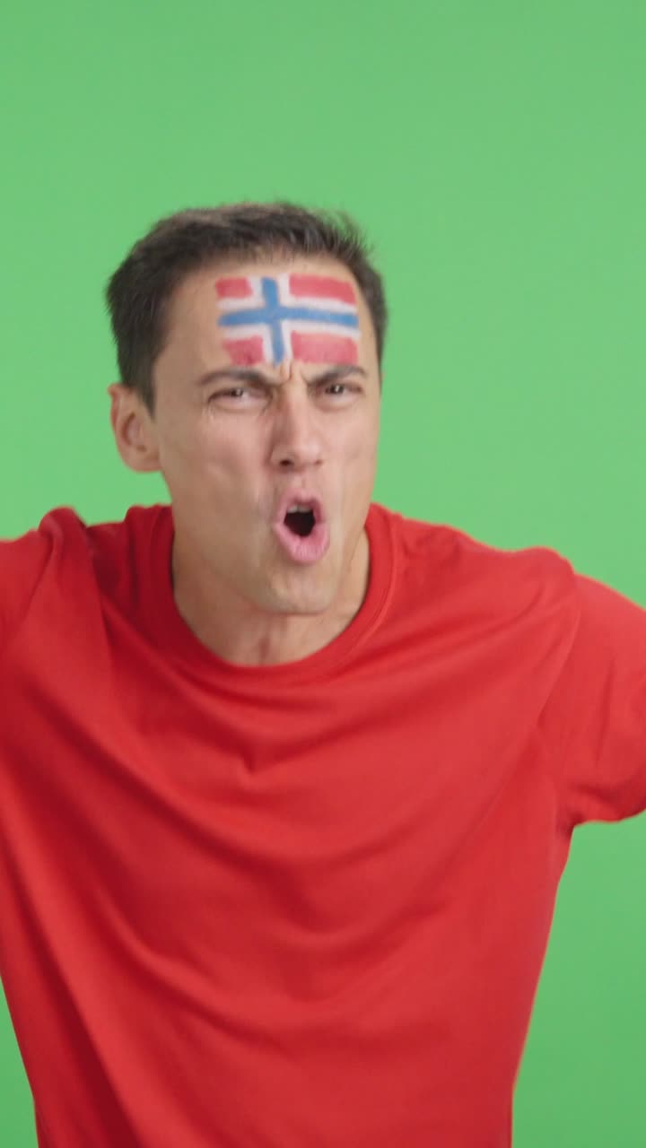 Man cheering for Norway screaming and waving a national flag