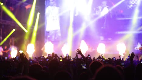 shiny stage of music concert blowing by neon colorful lights flashing and smoke