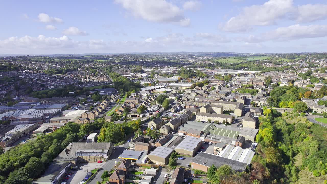 Aerial drone footage of the town of Heckmondwike which is a district in West Yorkshire, England UK, showing residential housing estates, and semi detached houses in the summer time