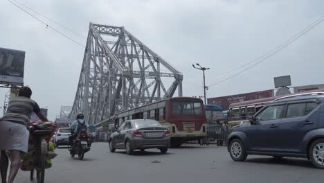 bustling street scene with howrah bridge in kolkata, india