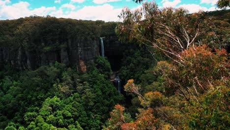 belmore falls, australia, drone of two tier waterfall in a dense forest