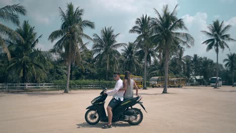 slim girl sits on boyfriend motorcycle couple rides away