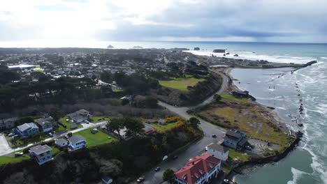 beautiful 4k aerial drone shot overlooking homes and sea in bandon, oregon