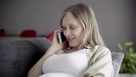 beautiful pregnant woman talking on smartphone