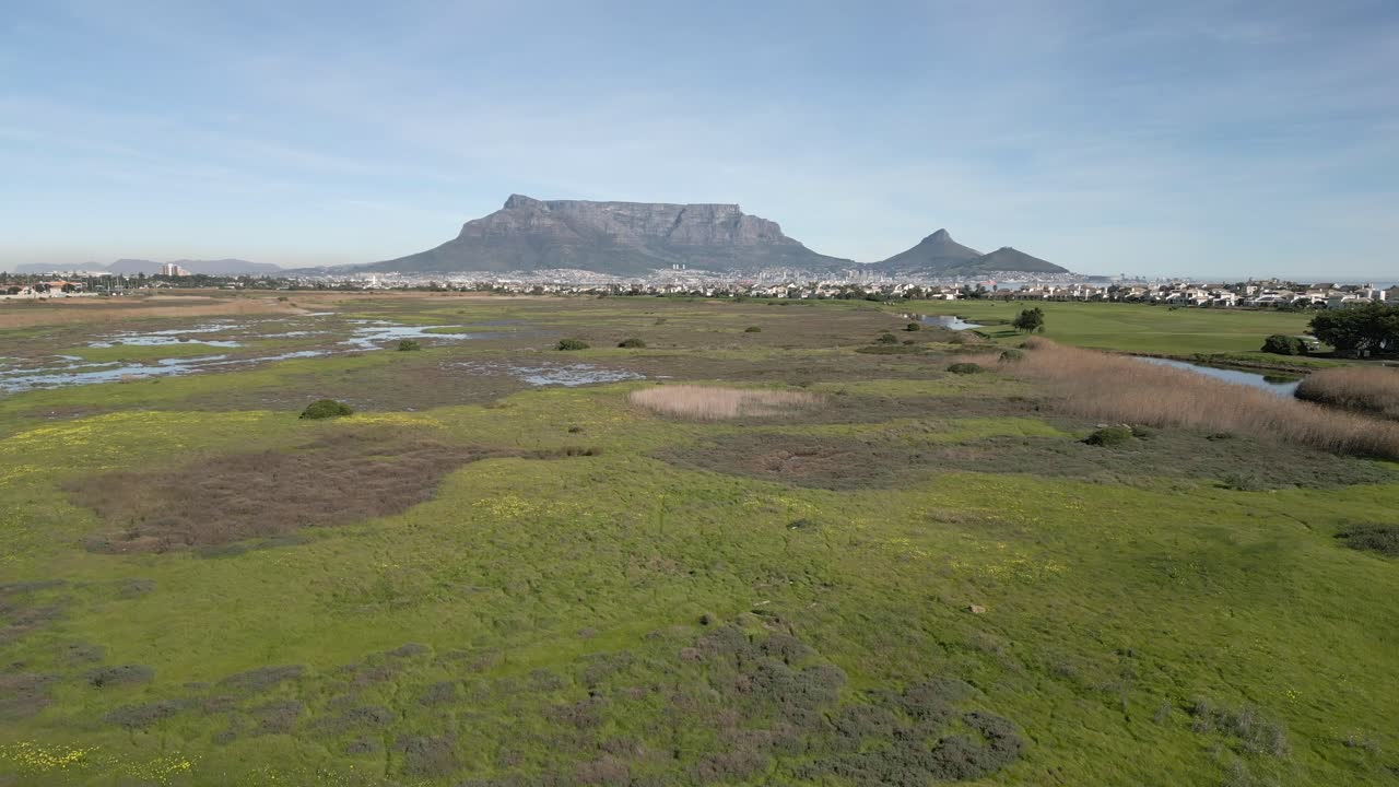 Drone shot over the Milnerton Golf course with Table Mountain off in the distance