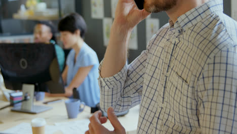 Close-up-of-male-executive-talking-on-mobile-phone-in-office-4k