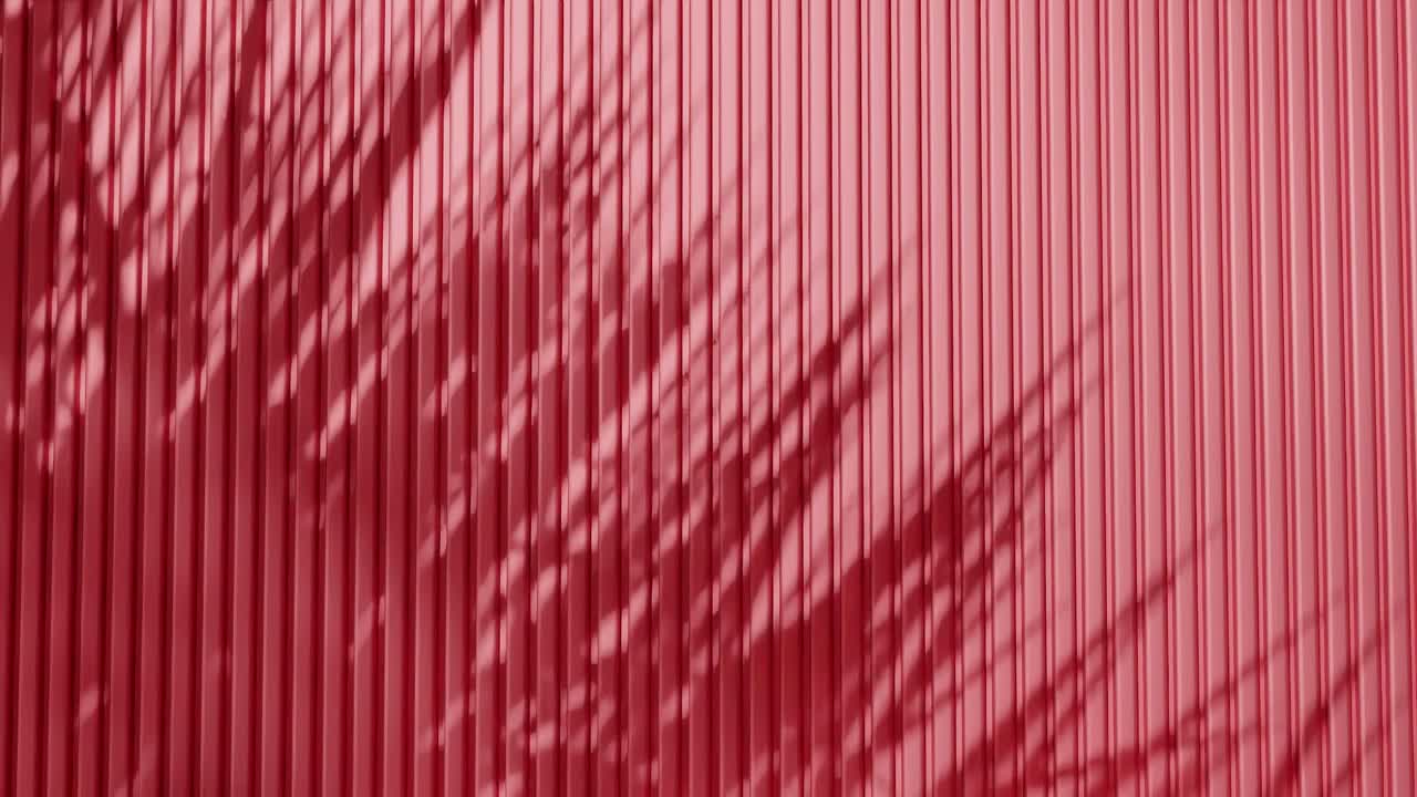 Shadow of palm leaves on vertical red corrugated metal wall. Abstract natural light and line pattern background. Design for wallpaper, banner, postcard, greeting card, poster, vertical