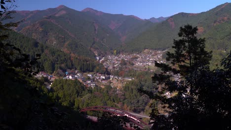 high above view out on mountain forest village in nature during bright day