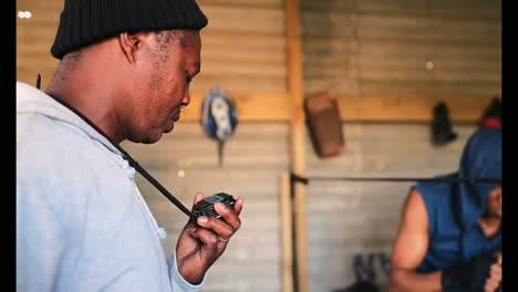 african american male boxer practicing boxing with trainer in fitness studio 4k