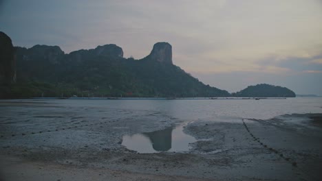 Looking-Across-Low-Tide-Beach-At-Railway-With-Coastline-Bay-In-Background