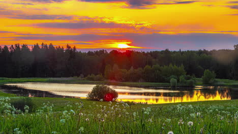 time lapse of cloudy sunset sky during golden hour with river in foreground