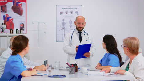 medical staff listening to lecture, asking questions and taking notes