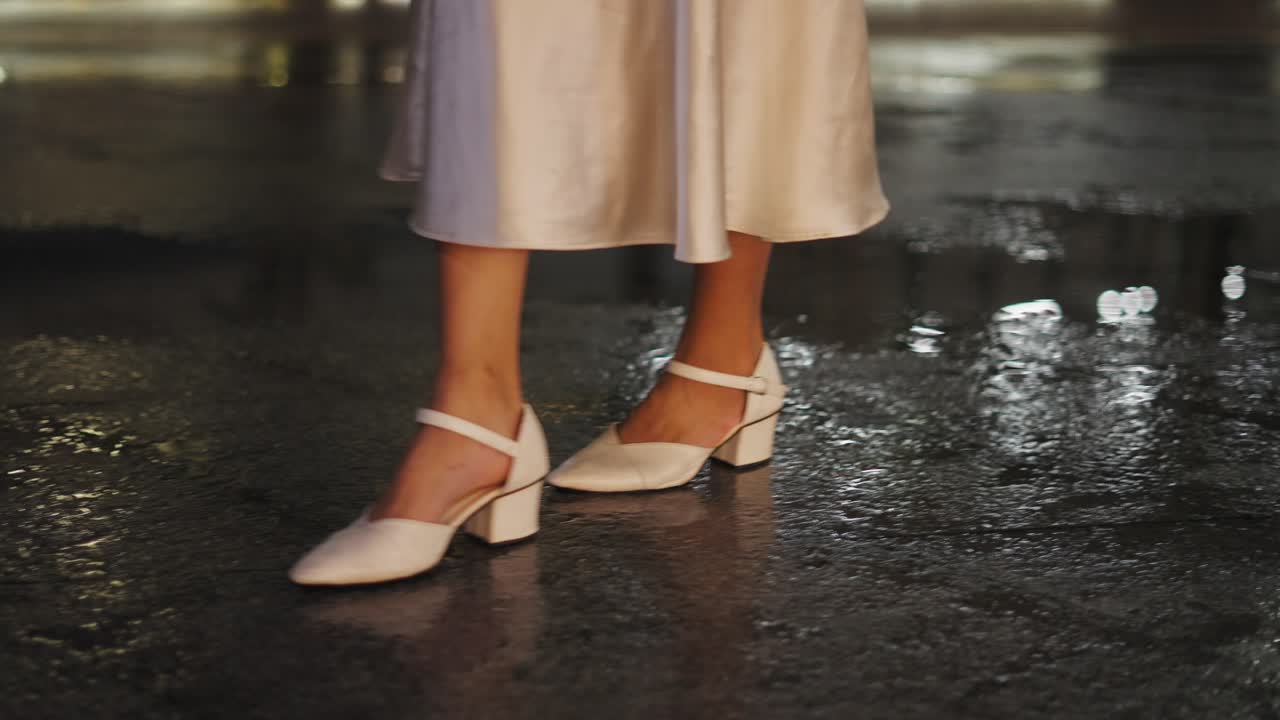 Woman in White Dress and Heels on a Wet Night