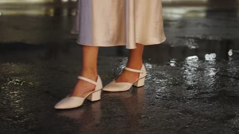 woman in white dress and heels on a wet night