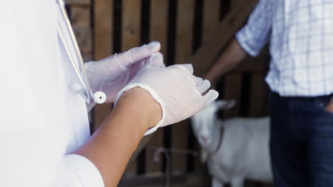 woman putting gloves on