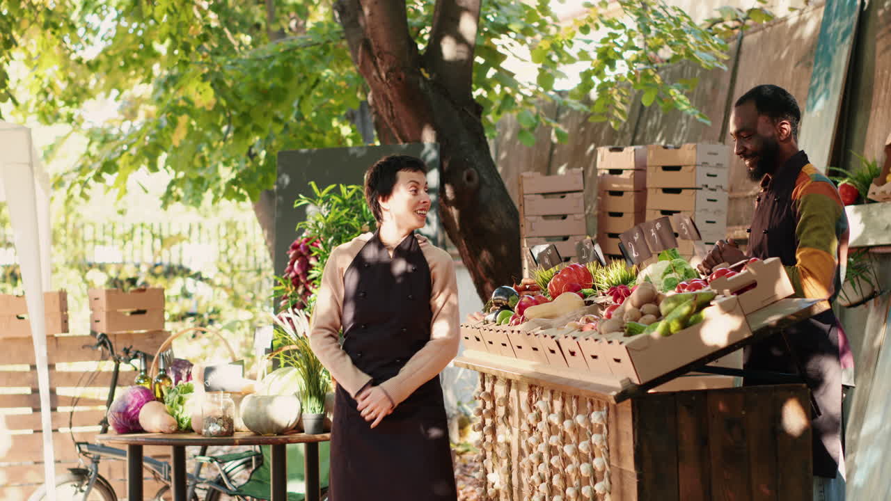 Customers buying fresh produce at a farmers market stall